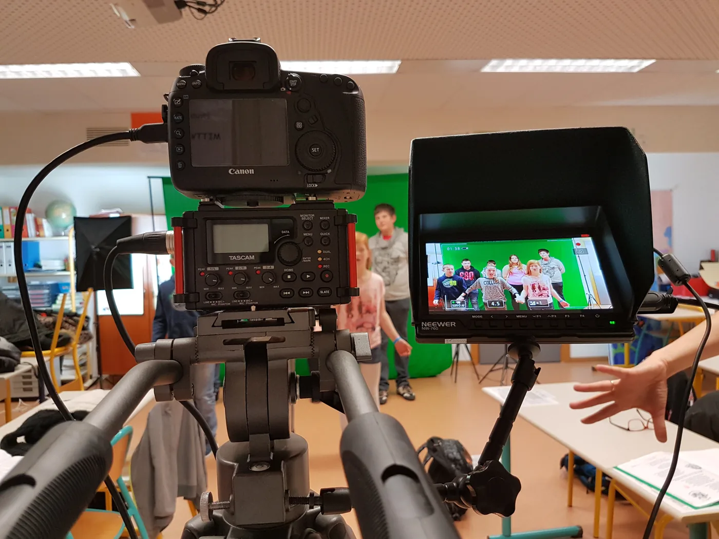 Une caméra sur trépied filme les élèves, dont l’image apparaît sur le moniteur de contrôle.